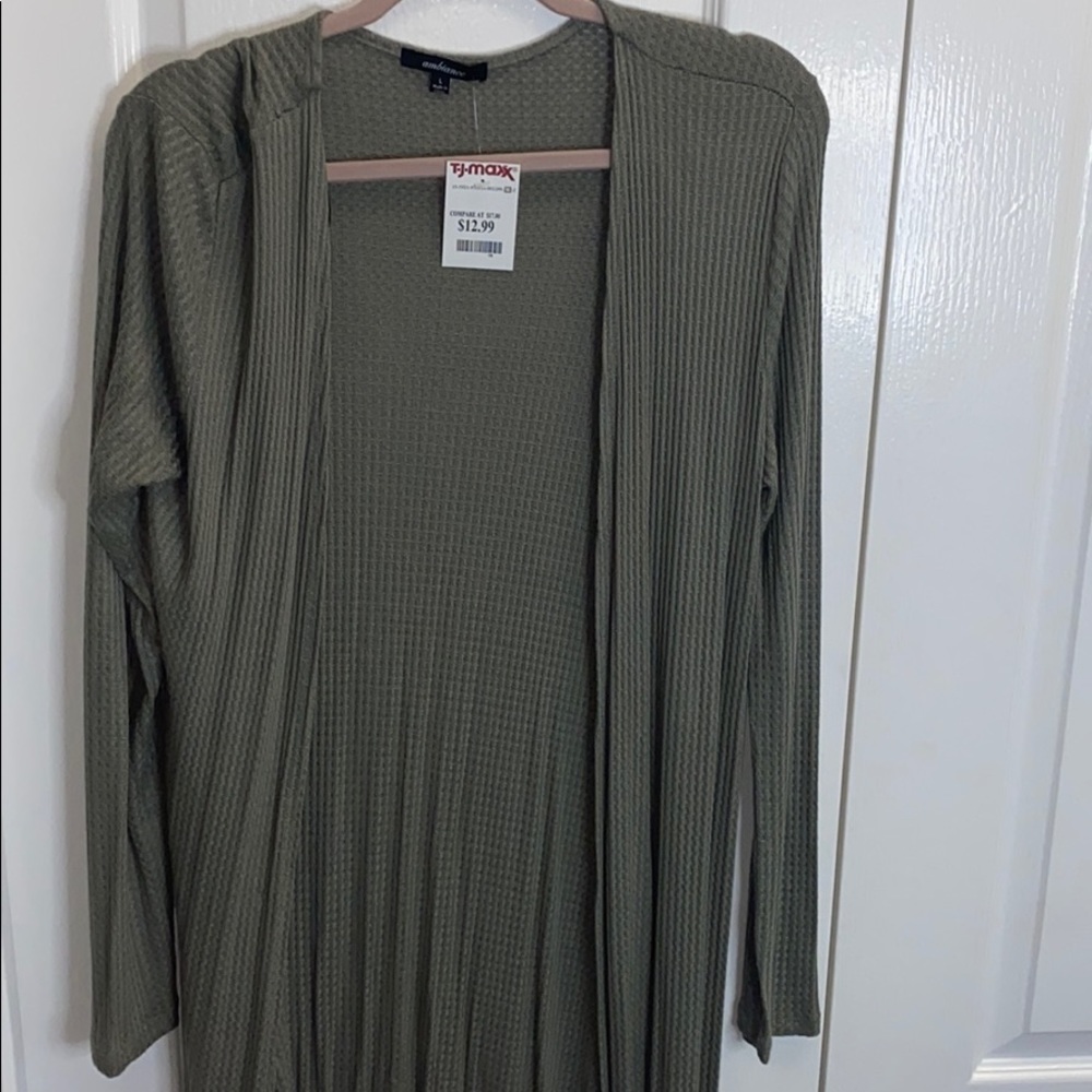 Green cardigan longer and has slits on the side